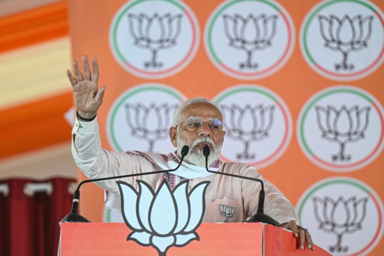 Narendra Modi, India's prime minister, center, during a campaign rally in Agra, Uttar Pradesh, India, on Thursday, April 25, 2024. Modi doubled down on his attacks against the main opposition party by using language critics say sows division between the country's Hindu majority and Muslim minority. Photographer: Prakash Singh/Bloomberg via Getty Images